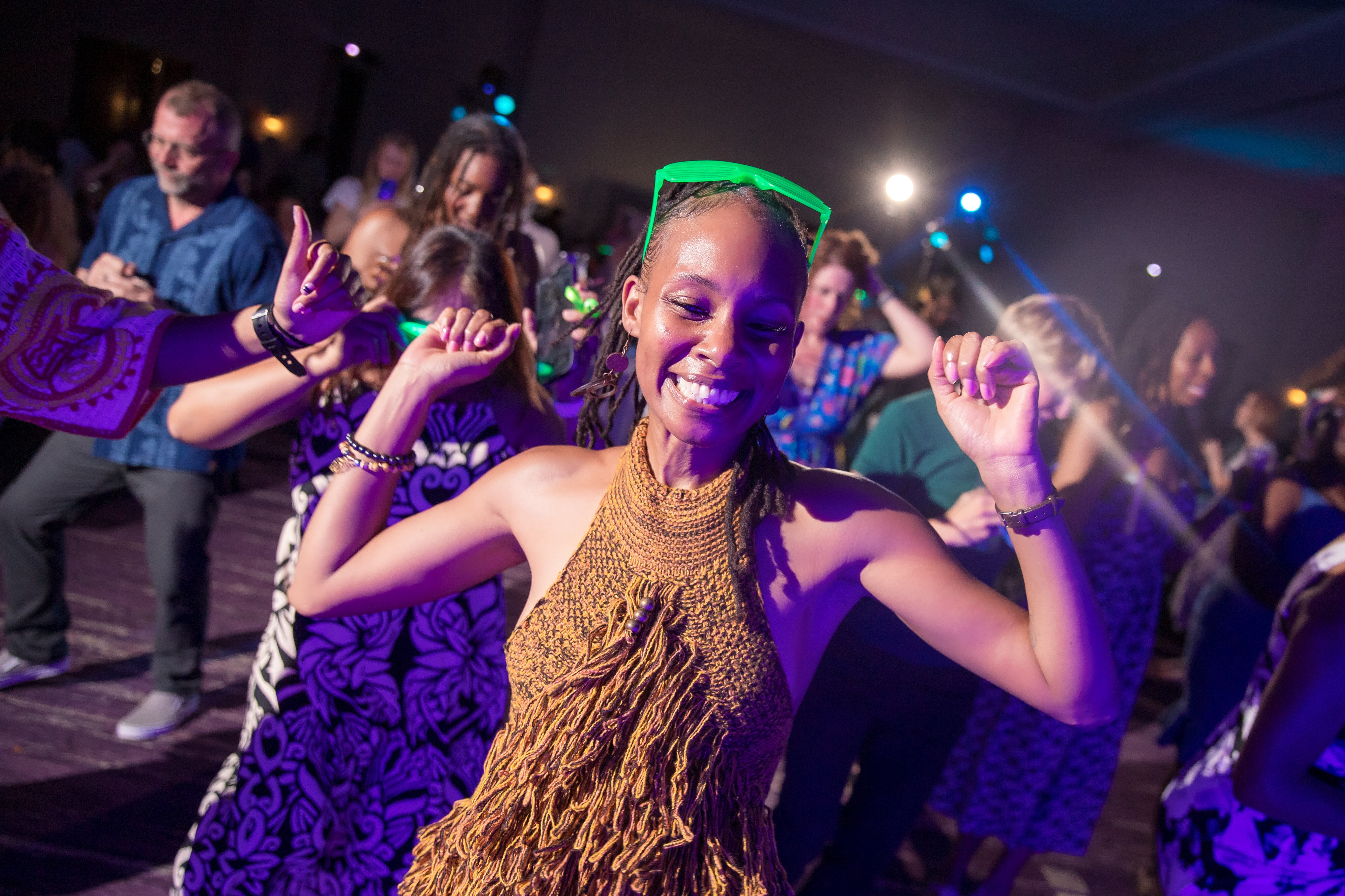 Woman smiling and dancing at a party