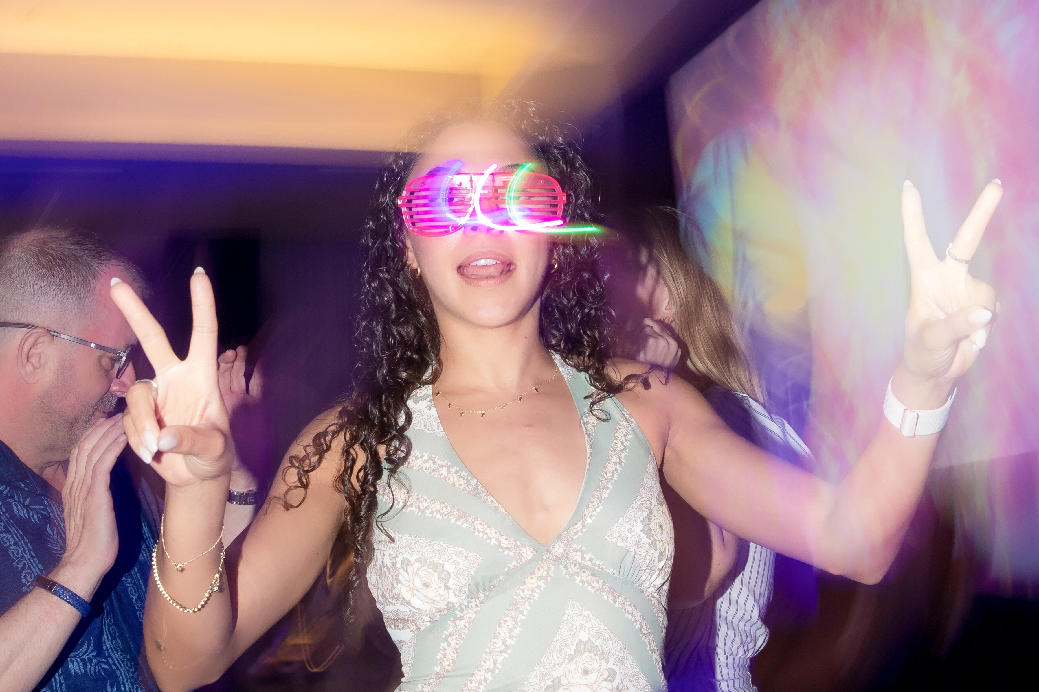 Woman enjoying a party with fun sunglasses.